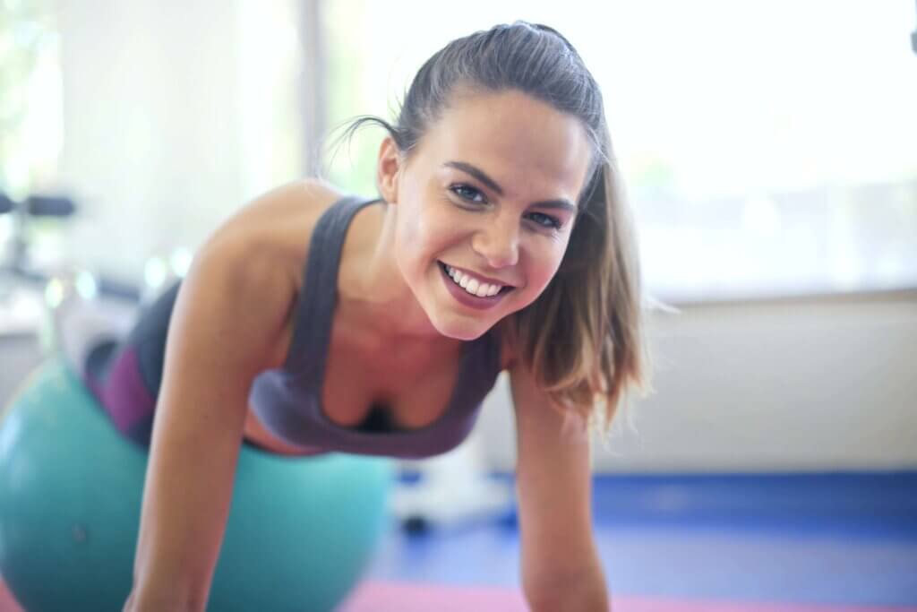 smiling woman using a stability ball