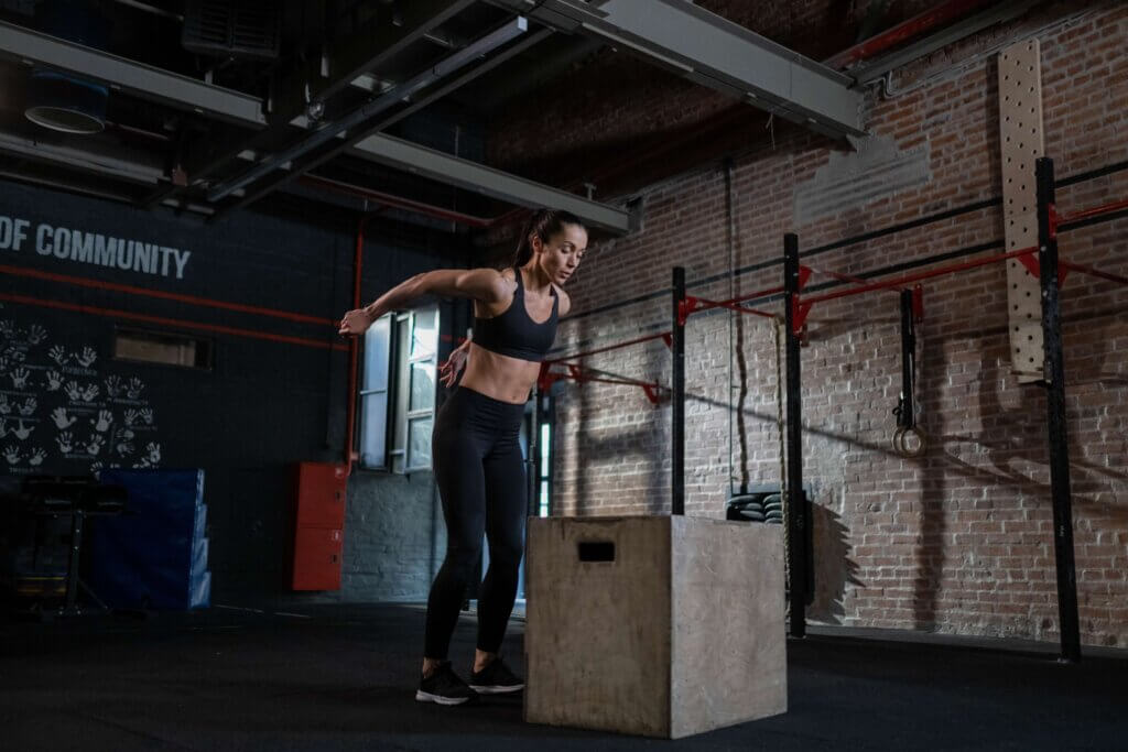 Woman preparing to do a box jump in her gym
